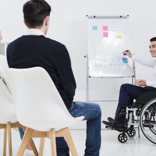 handicapped-young-businessman-giving-presentation-business-colleague
